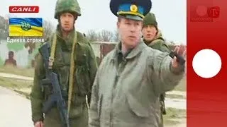 Video: Russian troops fire warning shots as Ukrainian military march towards Crimea air base