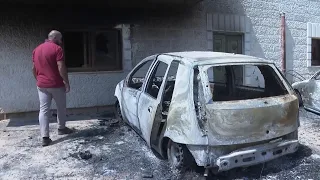 Residents inspect burned cars and homes after Israeli settlers rampaged through village in West Bank