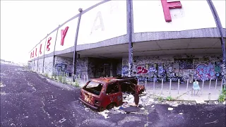 Rod Stewart "Young Turks" playing from the external speakers of an abandoned shopping center
