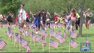 Scenic Middle School students place memorial flags at Eagle Point cemetery