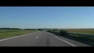 Helicopter Armed Forces of Ukraine is flying over the road.