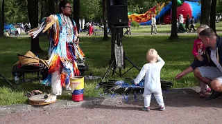 The baby is lit up with an Indian from Ecuador! Dance of the child.