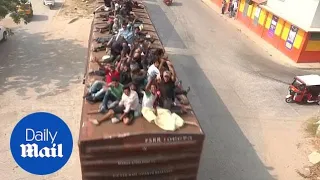 Hundreds of Central Americans ride top of train known as 'La Bestia'