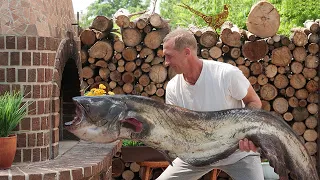 Cooking a large catfish in a wood stove.