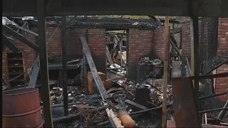 Neighbors spring into action after home next door catches fire with woman inside