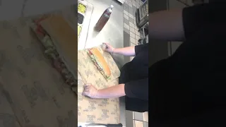 Applying Vinegar and Olive Oil to a Large Sandwich and Wrapping it