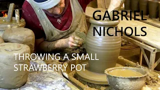 Gabriel Nichols throwing a small strawberry pot