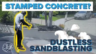 Dustless blasting to remove paint on a stamped concrete driveway