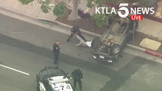 Pursuit driver taken into custody after PIT maneuver causes truck to flip over in Mid-Wilshire area