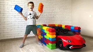 Mark builds garages for Lamborghini cars from colored toy blocks.