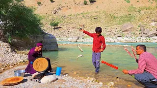 Catching fish by the nomadic family by the river and baking local bread by the nomadic woman