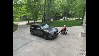 Grandma In Wheelchair Slides Down The Driveway