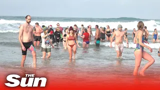 Boxing Day swimmers pull on fancy dress and take dip in freezing waters