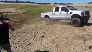 monster f350 pulls out ram stuck deep in mud