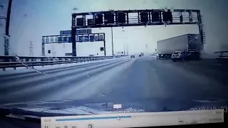 Car loses control and gets stuck under a semi truck trailer