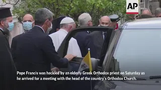 Police subdue priest who shouted 'heretic' at Pope