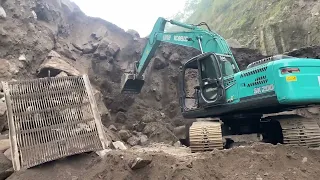 A large pile of rocks fell when an excavator loaded sand in a dump truck