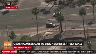 RAW: Crash causes car to sink near Desert Sky Mall in Phoenix