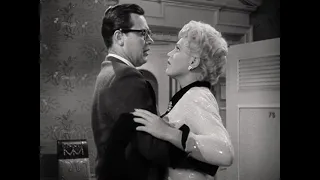 Billie (Judy Holliday) swoons after kissing Paul (William Holden) in Born Yesterday.