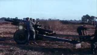 US 199th Light Infantry Brigade troops load, aim and fire 105mm Howitzer at their...HD Stock Footage