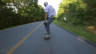 Downhill Skateboarder Falls Under Guardrail - 989283