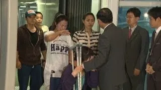 Asiana attendants return home