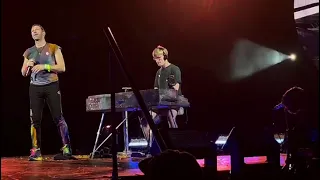 Chris Martin performing O Fly On with a fan at Wembley (17-08-22)