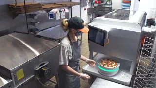 Robot making pizzas at a pizza shop