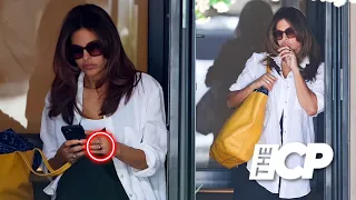 Eva Mendes flashes a gold ring on her wedding finger while leaving a salon in Sydney