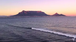 4K aerial drone footage of Table Mountain at sunrise as viewed across Table Bay  in Cape Town