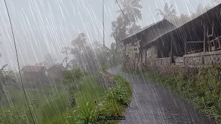 Walking under heavy rain in the hudden village