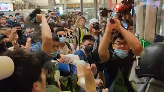 Hong Kong policeman draws pistol on protesters after being beaten with own baton