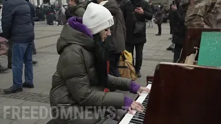 Woman Plays Piano for Refugees at Lviv Train Station