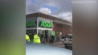 shoppers are evacuated after a huge fire erupts at an Asda superstore