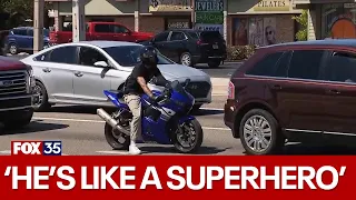 Florida motorcyclist jumps off bike to push man in wheelchair across street