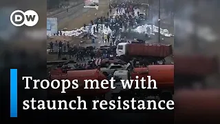 Footage shows how citizens try to stall Russian forces all over Ukraine | DW News