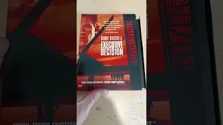 Removing the shrink-wrap on a 1997 DVD of Executive Decision