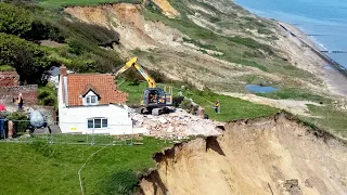 Farmhouse left hanging over perilous cliff edge demolished | SWNS