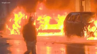 Looters damage downtown Seattle stores, set fire to police cars