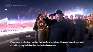 Kim Jong Un shows off daughter, missiles at North Korean military parade
