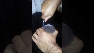 How to open a tin with a knife.
