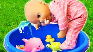 Baby Annabell doll plays with water at the swimming pool. Pretend play babysitter for baby dolls.