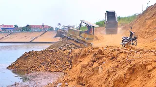 Pour soil mixed with rocks into water to complete large projects / Dump Truck 25 ton and Bulldozer