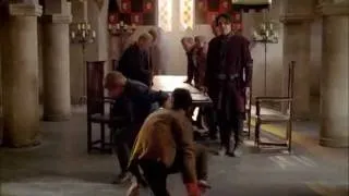 Merlin pulls off Arthur's pants and they wrestle on the floor