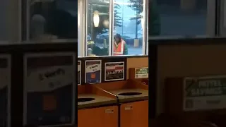 Angry homeless man destroy glass at McDonalds