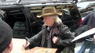 Brad Whitford of Aerosmith signs for fans outside his hot...