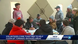 Volunteers come together to help clean up storm damage in Palmer, Iowa