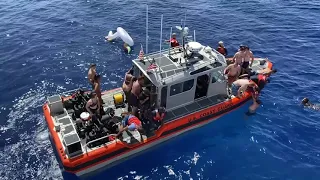 RAW: Coast Guard fires at shark to protect crew swimming in the ocean