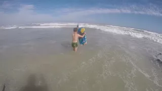 Boy learning how to bodyboard at Muizenberg Beach