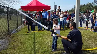 Spraying firefighter water hose